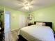 Well lit bedroom with wood-look flooring, ceiling fan and large wardrobe at 1125 Almond Tree Cir, Orlando, FL 32835