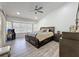 Well lit bedroom featuring neutral color scheme, ceiling fan, vinyl flooring and furniture at 1125 Almond Tree Cir, Orlando, FL 32835