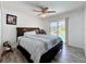 Inviting bedroom with a sliding glass door to the backyard pool and a ceiling fan at 1125 Almond Tree Cir, Orlando, FL 32835