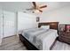 Comfortable bedroom with a ceiling fan, laminate wood flooring, and double-door closet at 1125 Almond Tree Cir, Orlando, FL 32835