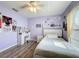 Bright bedroom with a ceiling fan, modern wood flooring, window and white furniture at 1125 Almond Tree Cir, Orlando, FL 32835
