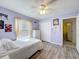 Cozy bedroom with ample natural light, ceiling fan, closet, and modern wood-look flooring at 1125 Almond Tree Cir, Orlando, FL 32835