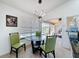 Breakfast nook with modern lighting, glass table, and views of the pool area at 1125 Almond Tree Cir, Orlando, FL 32835