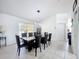 Elegant dining room features a modern chandelier and a black marble-top table with seating for eight at 1125 Almond Tree Cir, Orlando, FL 32835