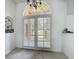 Bright entryway features tile floors, a decorative chandelier, and double doors with a transom window above at 1125 Almond Tree Cir, Orlando, FL 32835