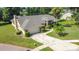 Stunning exterior view of home with landscaped yard, lake, and driveway at 1125 Almond Tree Cir, Orlando, FL 32835