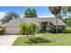 Beautiful home with lush landscaping, arched entryway, garage and driveway at 1125 Almond Tree Cir, Orlando, FL 32835
