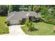 Beautiful home featuring lush landscaping, driveway, lawn and an inviting entry way at 1125 Almond Tree Cir, Orlando, FL 32835