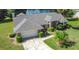 Beautiful home featuring lush landscaping, garage, lawn, and an inviting entry way at 1125 Almond Tree Cir, Orlando, FL 32835