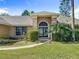 Inviting front entrance with double doors, manicured lawn, walkway and beautiful shrubbery at 1125 Almond Tree Cir, Orlando, FL 32835