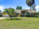 Beautiful home featuring a lush green lawn, arched entryway, and a well-manicured lawn at 1125 Almond Tree Cir, Orlando, FL 32835