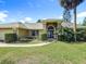 Charming home featuring an arched entryway, green lawn, driveway and beautiful shrubbery at 1125 Almond Tree Cir, Orlando, FL 32835