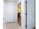 Hallway featuring tile floors and views to an adjacent bedroom, closet, and secondary room at 1125 Almond Tree Cir, Orlando, FL 32835
