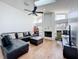 Bright living room with a fireplace, skylights, hardwood floors and comfortable seating at 1125 Almond Tree Cir, Orlando, FL 32835