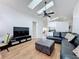 Open concept living room with hardwood floors, modern lighting and skylight at 1125 Almond Tree Cir, Orlando, FL 32835