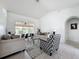 Bright living room showcasing stylish furniture, tile floors, and large windows with a view of the pool at 1125 Almond Tree Cir, Orlando, FL 32835