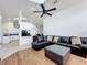 Comfortable living room featuring a sectional sofa, skylights, and open access to the kitchen at 1125 Almond Tree Cir, Orlando, FL 32835