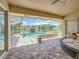 Charming covered patio overlooking a sparkling pool and picturesque waterfront scenery at 1125 Almond Tree Cir, Orlando, FL 32835