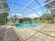 Sparkling screened-in pool with brick paver surround and tranquil water views, perfect for relaxation at 1125 Almond Tree Cir, Orlando, FL 32835