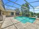 Refreshing pool area with screened enclosure, brick pavers, and beautiful views of the surrounding scenery at 1125 Almond Tree Cir, Orlando, FL 32835