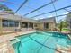 Inviting screened pool surrounded by brick pavers with lush landscaping, providing a private oasis at 1125 Almond Tree Cir, Orlando, FL 32835