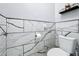 Modern powder room featuring marble-look tile, elegant toilet and modern fixtures at 1125 Almond Tree Cir, Orlando, FL 32835