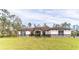 Inviting single story home featuring a well-manicured lawn, stone accents, and a cozy front entrance at 18623 Tunbridge St, Orlando, FL 32833
