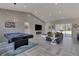 Spacious living room with vaulted ceilings, fireplace, pool table, and a wall-mounted TV at 18623 Tunbridge St, Orlando, FL 32833