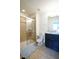 Bathroom featuring a glass-enclosed shower, toilet, sink, vanity, and beige tile flooring at 1929 Nice Ct, Kissimmee, FL 34747
