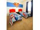 Nicely decorated bedroom with two twin beds featuring superhero themed decorations, bedding, and a colorful accent wall at 1929 Nice Ct, Kissimmee, FL 34747
