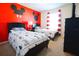 Charming bedroom featuring two twin beds, a red accent wall with Mickey Mouse decals, and bright natural light at 1929 Nice Ct, Kissimmee, FL 34747