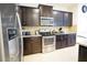 Modern kitchen featuring stainless steel appliances, granite countertops, and dark wood cabinets at 1929 Nice Ct, Kissimmee, FL 34747