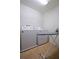 Laundry room featuring a washer, dryer, an ironing board, and tiled flooring at 1929 Nice Ct, Kissimmee, FL 34747