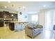 Inviting living room and open floor plan with a kitchen island, adjacent to dining area with lots of natural light at 1929 Nice Ct, Kissimmee, FL 34747