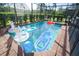 Sparkling screened-in pool area surrounded by lush greenery, including inflatables for relaxation and fun at 1929 Nice Ct, Kissimmee, FL 34747