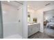 Bright bathroom featuring a shower and double sinks, with a view to the bedroom at 21 Locust Ter, Ocala, FL 34472