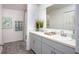 Bright bathroom featuring double sinks, a large mirror, and modern fixtures at 21 Locust Ter, Ocala, FL 34472