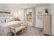 Bright bedroom featuring a comfortable bed, window view, and stylish decor at 21 Locust Ter, Ocala, FL 34472