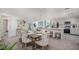 Open-concept dining room with stylish furnishings, stainless steel appliances, and a seamless flow into the kitchen and living areas at 21 Locust Ter, Ocala, FL 34472