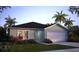 Single-story home features an attached two-car garage and is surrounded by lush landscaping and green grass at 21 Locust Ter, Ocala, FL 34472