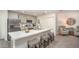 Modern kitchen with stainless steel appliances, gray cabinets, kitchen island with seating, and open to the living area at 21 Locust Ter, Ocala, FL 34472