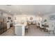 Open-concept living area with stainless appliances, a kitchen island with seating, and a dining area at 21 Locust Ter, Ocala, FL 34472