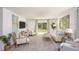 Bright living room with comfortable seating, large windows, and stylish decor offers a relaxing and inviting space at 21 Locust Ter, Ocala, FL 34472