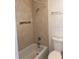 Bathroom featuring a tiled shower/tub and toilet at 2525 Caper Ln # 205, Maitland, FL 32751