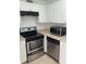 Modern kitchen featuring stainless steel appliances, white cabinets, and neutral countertops at 2525 Caper Ln # 205, Maitland, FL 32751
