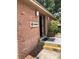 Brick building featuring a laundry room entrance with steps and visible sign, offering convenient on-site laundry facilities at 2525 Caper Ln # 205, Maitland, FL 32751