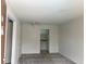 View of the living room with grey carpet leading to the kitchen with white cabinets at 2525 Caper Ln # 205, Maitland, FL 32751