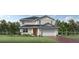 Inviting two-story home featuring a two-car garage, well-manicured lawn, and a mix of modern architectural details at 2577 Fiddle Leaf Loop, Apopka, FL 32712