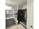 Modern bathroom featuring stylish vanity, tiled shower with glass door, and updated fixtures at 2740 Maitland Crossing Way # 2-303, Orlando, FL 32810