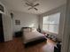 Cozy bedroom featuring wood floors, a ceiling fan, and natural light from a window with blinds at 2740 Maitland Crossing Way # 2-303, Orlando, FL 32810